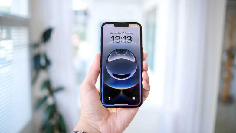 Apple's smartphone iPhone 16e being held by a person.