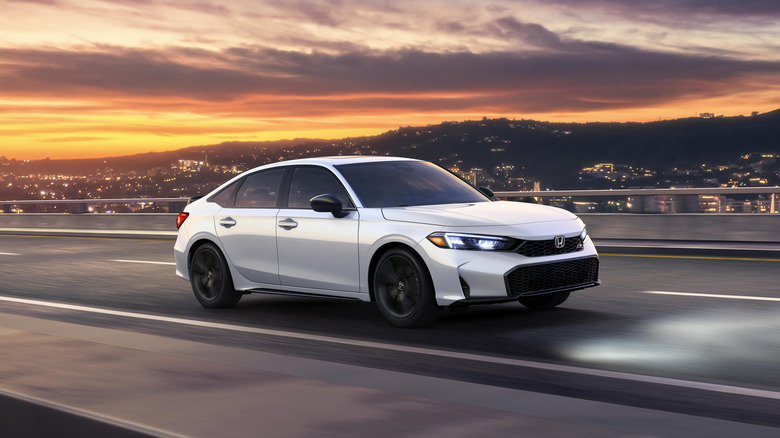Gray 2025 Honda Civic Si seen from front left against a mountain background