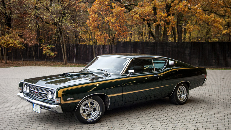 1968 Ford Fairlane Torino GT parked in front of woods, front-left 3/4 view