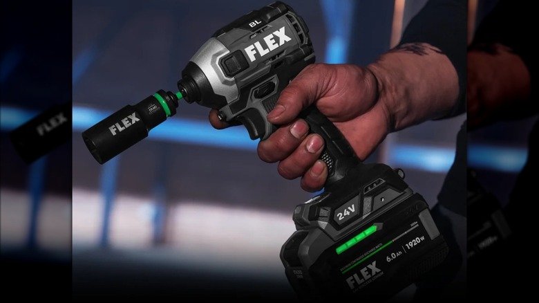 Hand gripping a Flex 24V ¼-inch hex impact driver