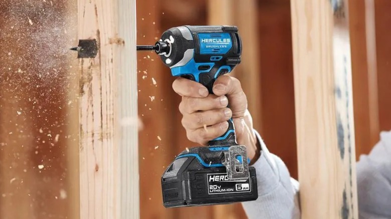 Person drilling into wood with a Hercules 20V ¼-inch compact 3-speed impact driver
