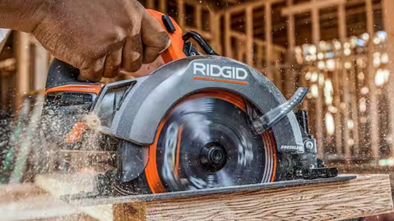 Person using Ridgid 18V Brushless Cordless 7 ¼-inch Circular Saw to cut board