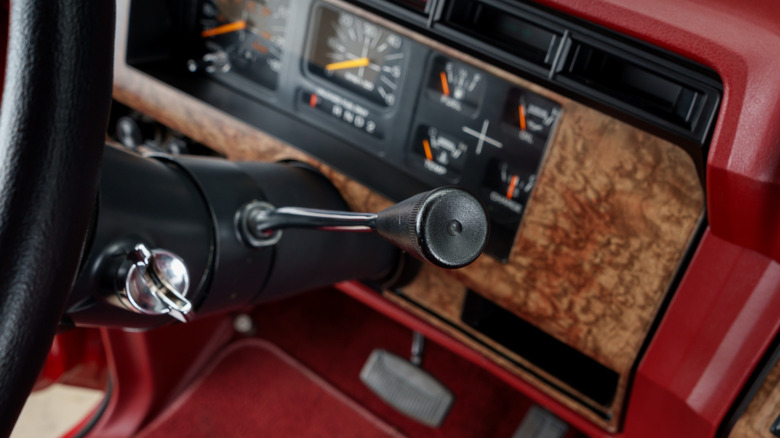 A close-up of a column shifter on a classic car