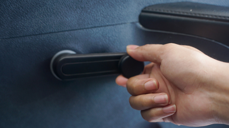 Person operating car window crank