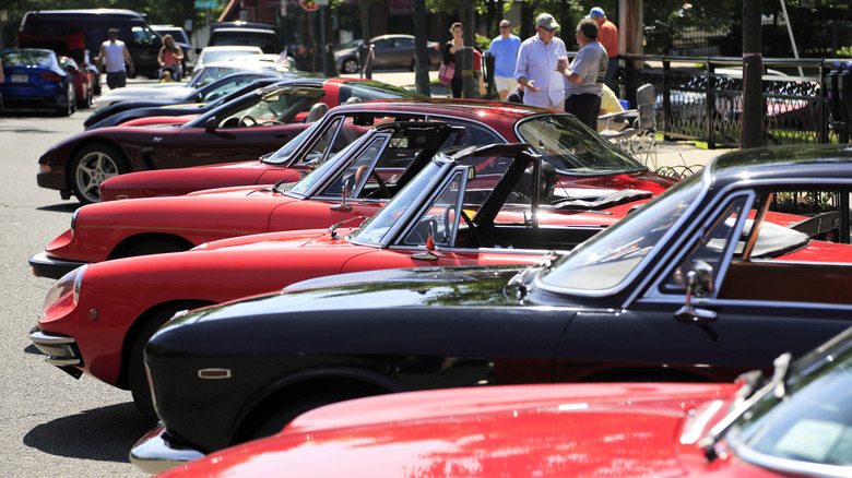 A row of colorful classic cars parked next to each other on display.