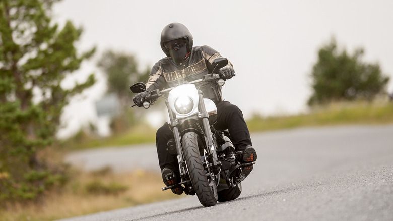 Man riding Harley Davidson motorcycle