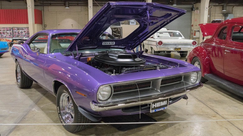 1970 Plymouth Hemi 'Cuda with hood open parked indoors at car show, front-right view
