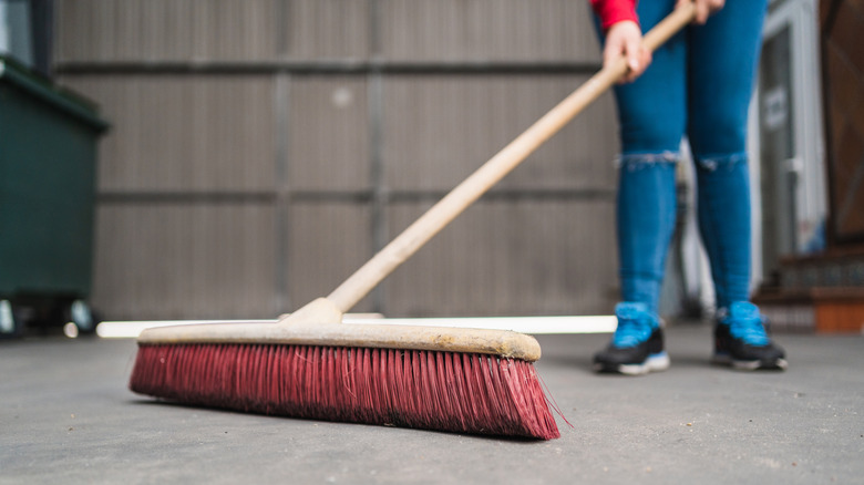 Person sweeping out their garage
