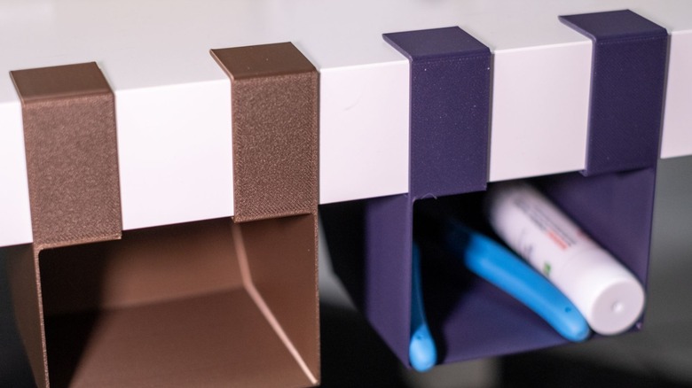 3D printed storage mounted under an Ikea Lack table.