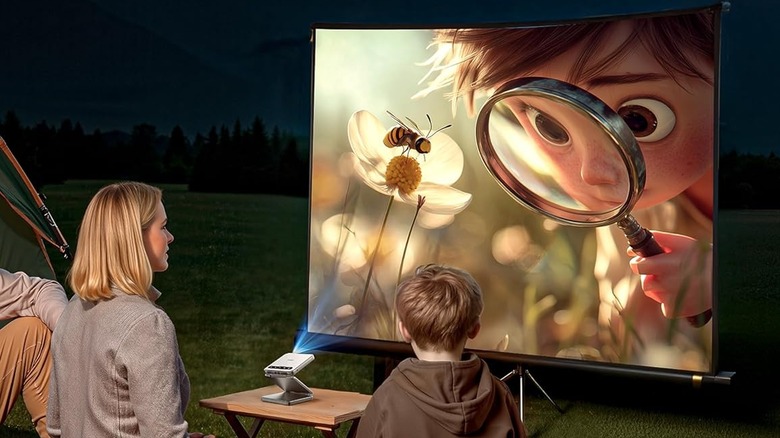 Two people watching an animated movie using a foldable projector