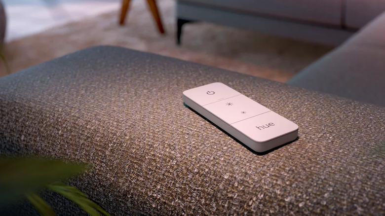 A picture of the Philips Hue Smart Wireless Dimmer Switch on a sofa.