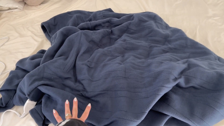 A picture of the Sunbeam Electric Heated Bed Blanket on a bed.