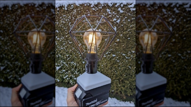 A Makita 18 volt battery with a lamp adapter attached.