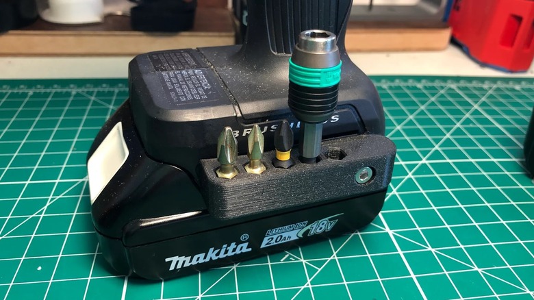 A 3D printed drill bit holder for a cordless Makita power drill.
