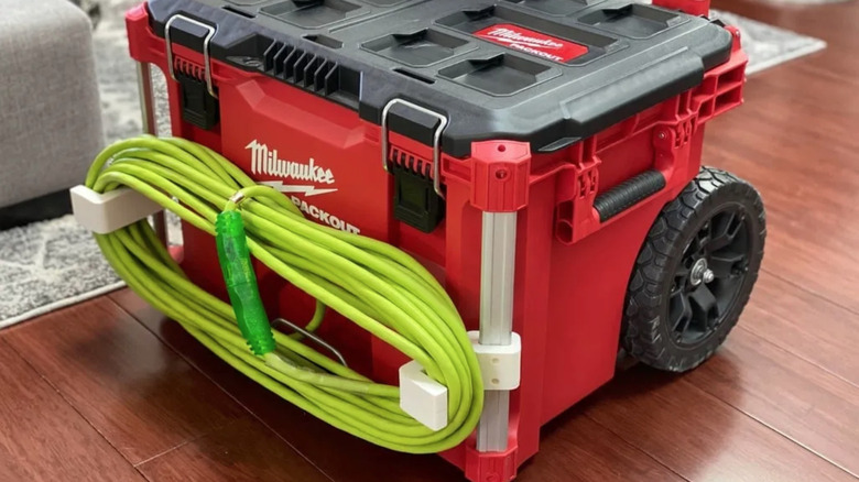 3D printed hooks holding extension cord on Milwaukee Packout roller