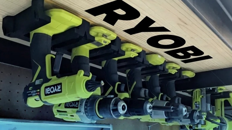 Ryobi tools hanging from 3D printed tool holders.