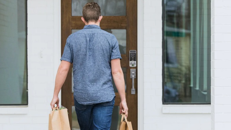 Man approaching door with Lockly Visage Zeno Series Smart Lock
