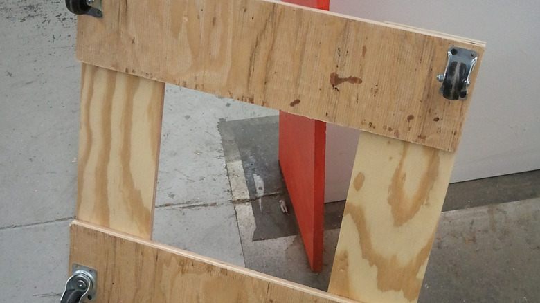 A furniture dolly against a wall.