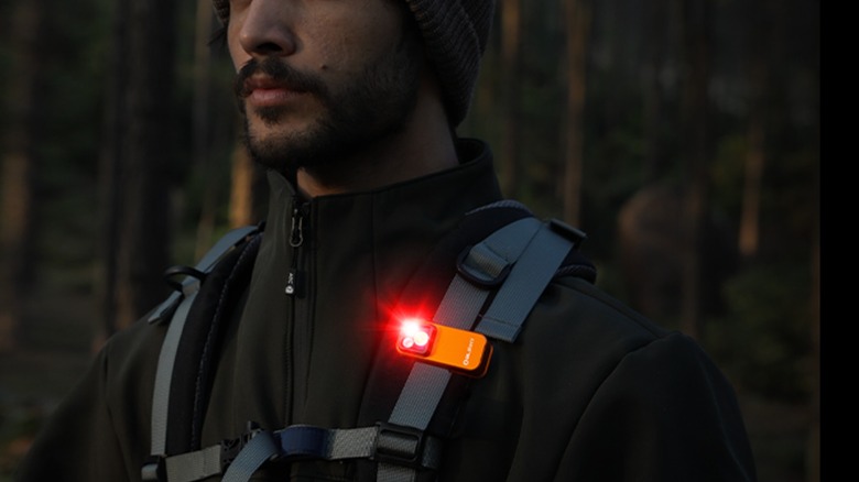 A man wearing clip-on light on strap