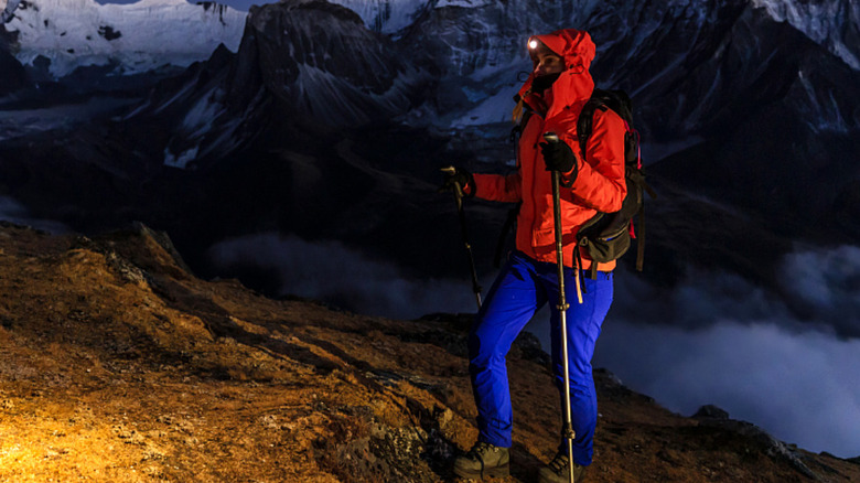 A person hiking with head visor light