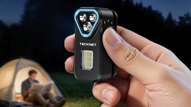 A person holding clip on flashlight