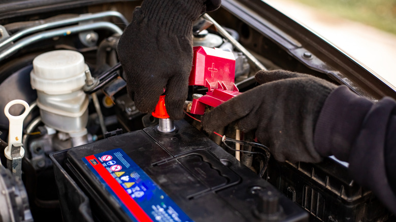 a man replacing a car battery