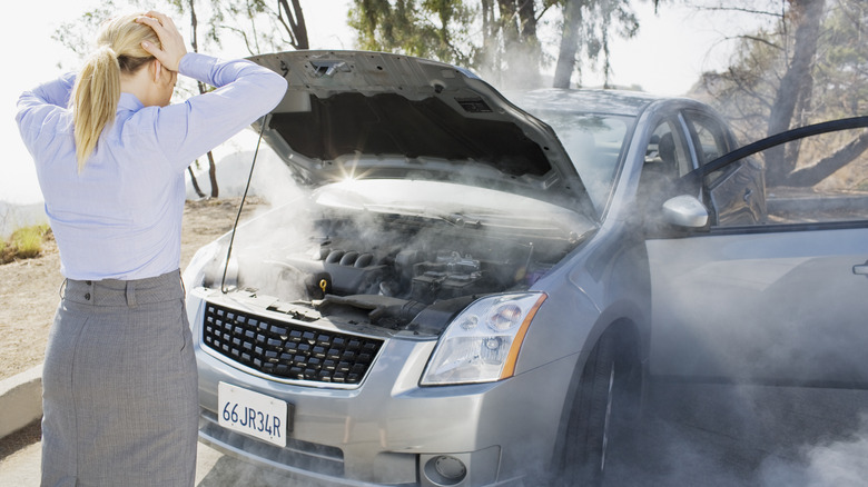 Woman with damaged car