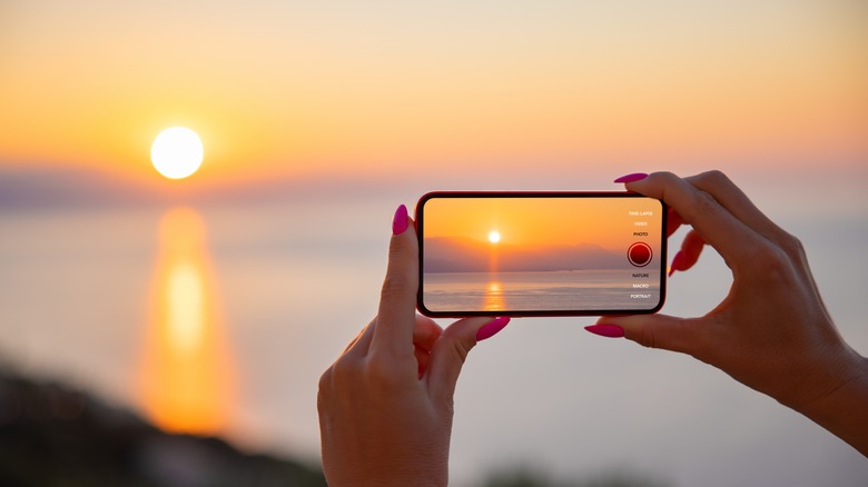 woman taking photo on phone