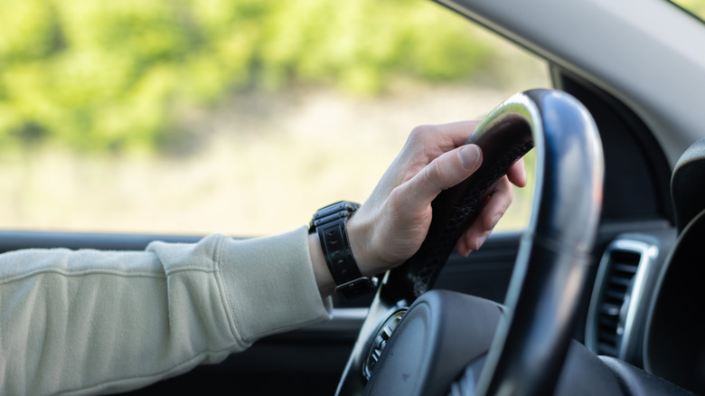 driving with one hand on the wheel