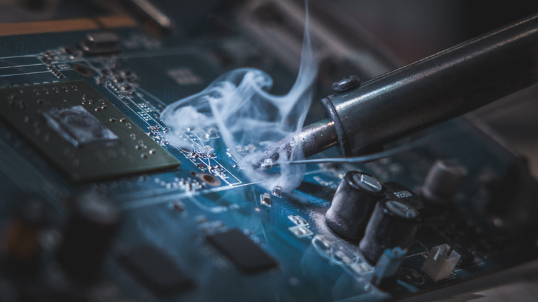 Close-up of smoke surrounding a soldering iron tip