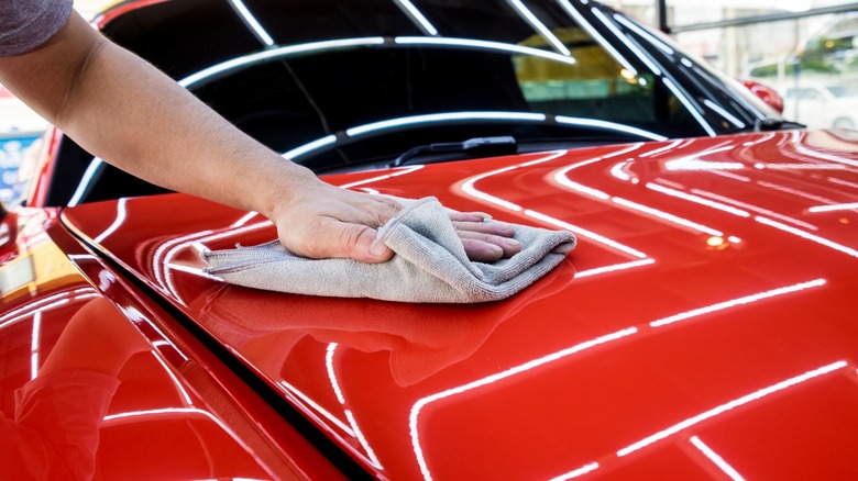 Wiping down a red car