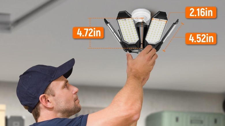 A man putting garage lights in.