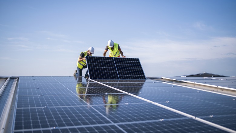 workers installing solar panels