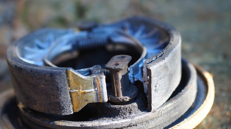 Close-up of weathered brake shoes on assembled drum brake