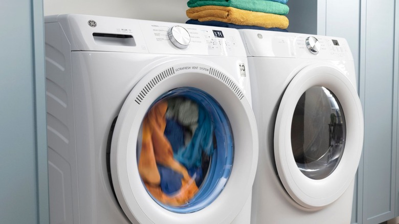 white GE washer running load of clothes