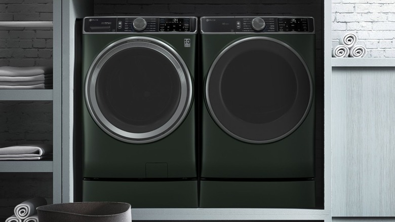 GE washer and dryer set up in laundry room