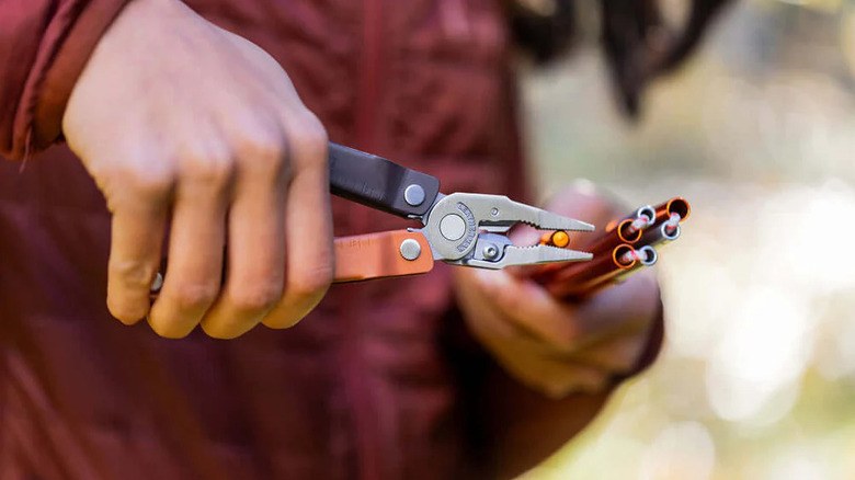 Hand holding Leatherman tool