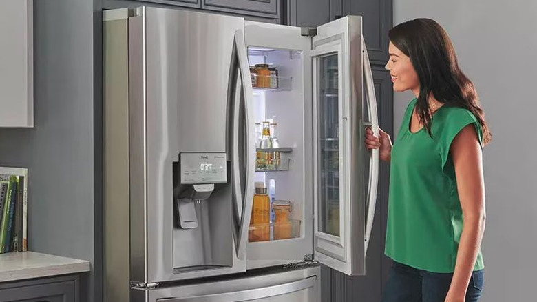 Woman opening an LG refrigerator