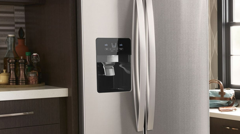 Closeup of the water and ice dispenser in a Whirlpool refrigerator