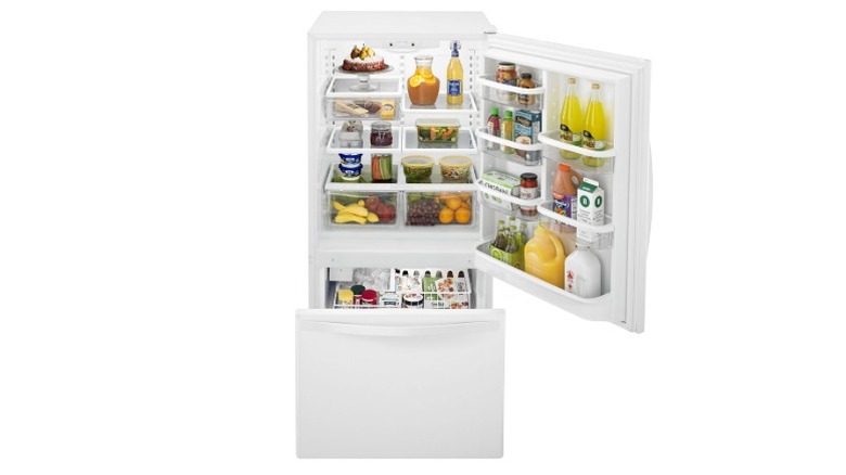 Brightly lit Whirlpool refrigerator with door open against a white background