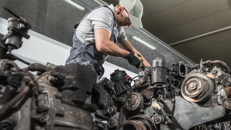 Mechanic working on truck diesel engine