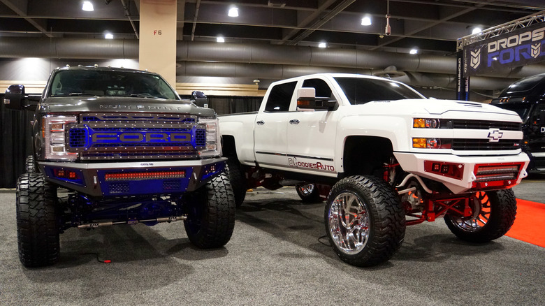 Lifted trucks parked in showroom
