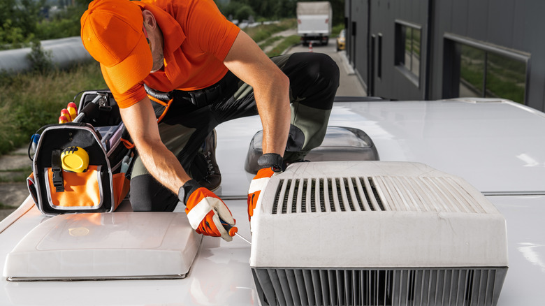 man fixing camper roof