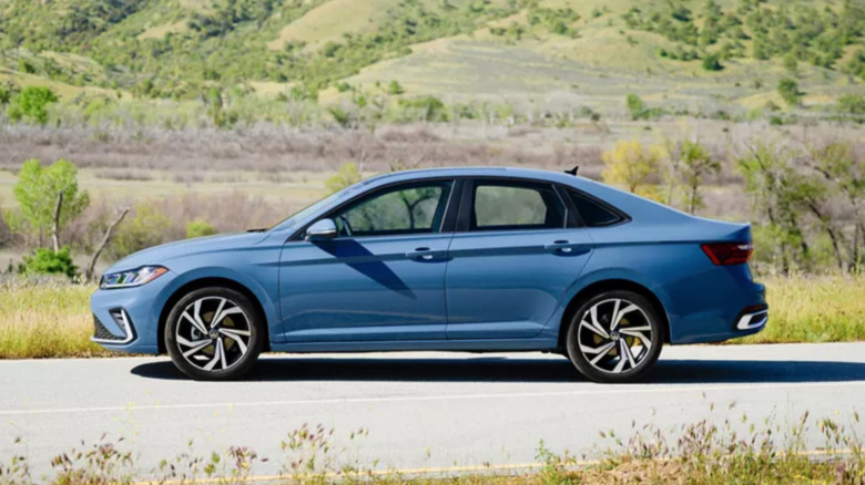 Volkswagen Jetta on road against hillside