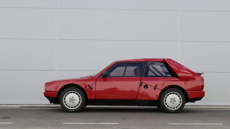 Lancia Delta S4 Stradale on white concrete background, left-side view