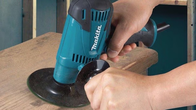 Person using Makita Compact Disc Sander