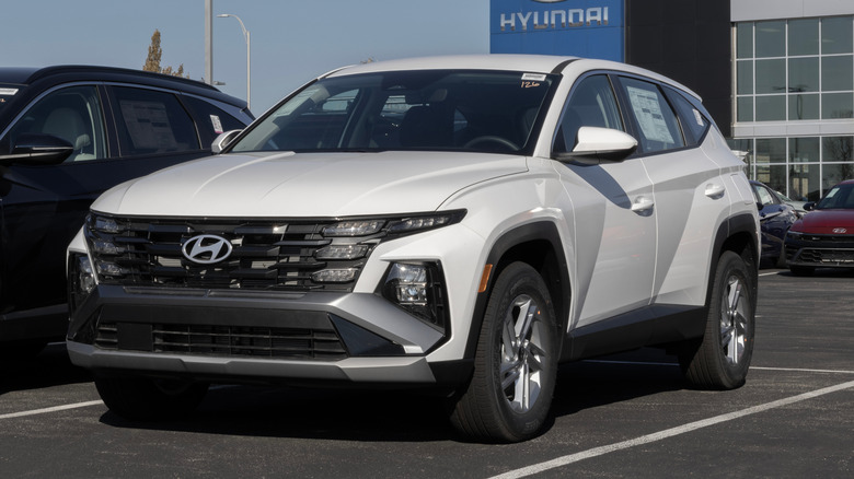 A white 2026 Hyundai Tucson parked on a dealership lot.