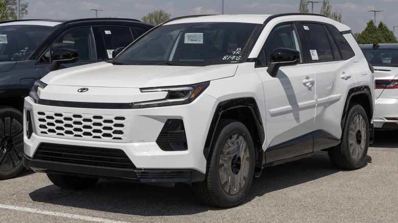 A white 2026 Toyota RAV4 parked at a dealership lot.