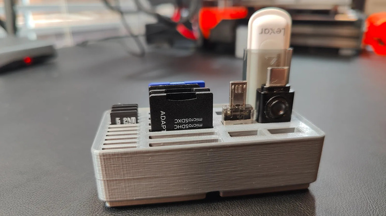Desk organizer holding SD cards, MicroSD cards, and USB sticks.