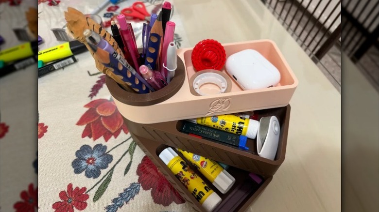Desk organizer with rotating drawers, full of stuff.